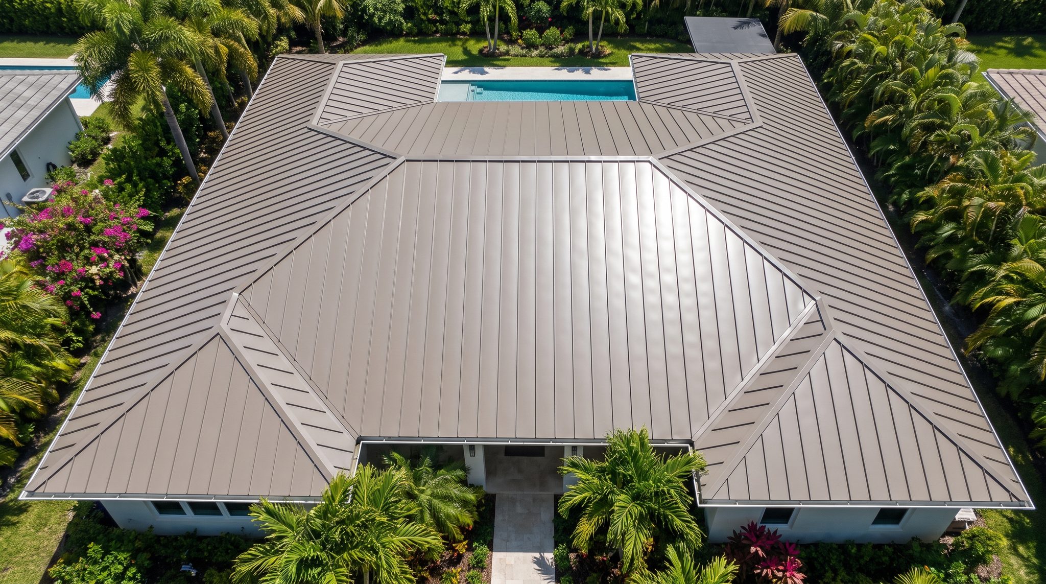 Aerial view of a grey standing seam metal roof with crisp ridge lines